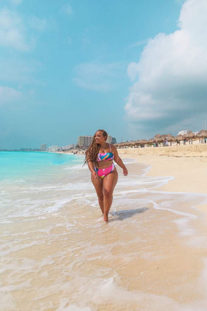 Black woman walking on beach